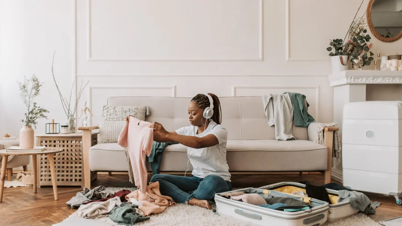 Person Checking List Organized Suitcase